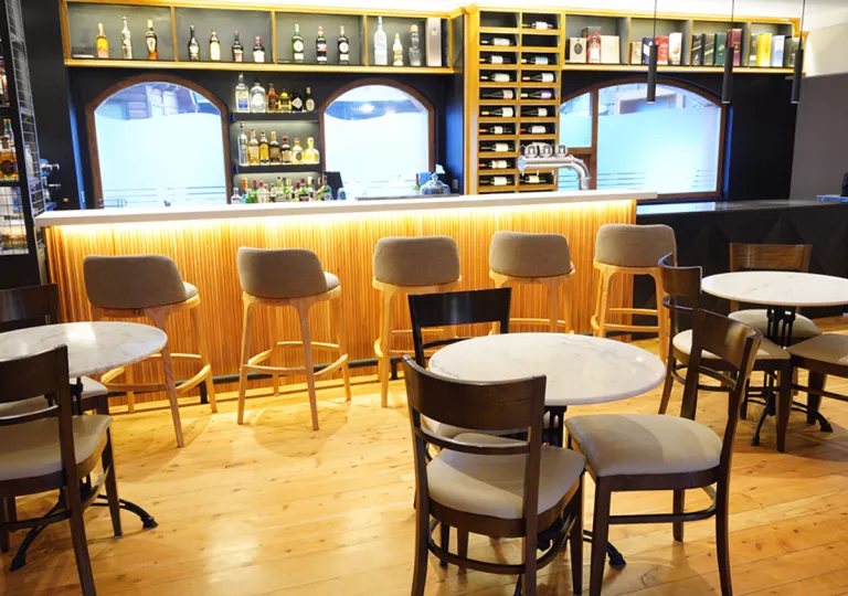 Bar and lounge with tall stools by a bar counter