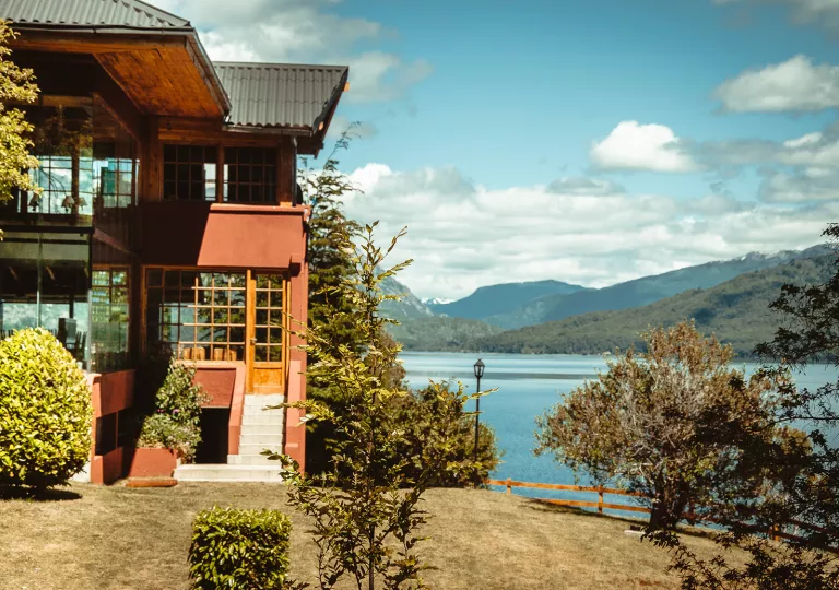 Exterior view of a red building next to a lake