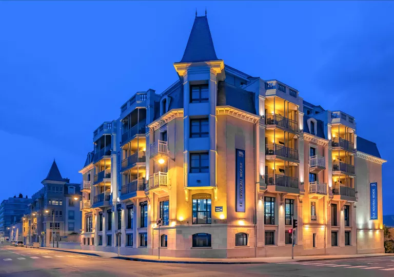 Exterior view of building illuminated by orange lights