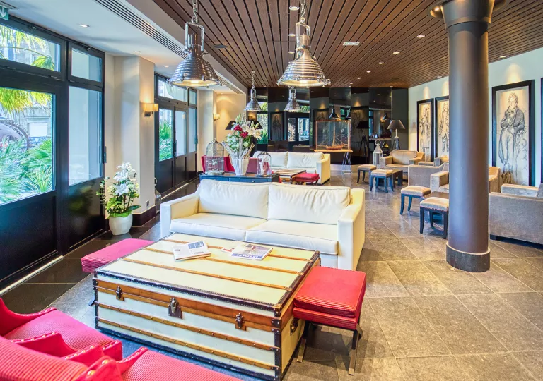 Lounge with cushioned sofas and metal pillars