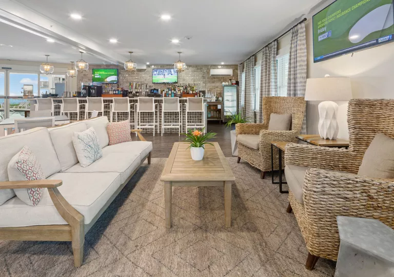 Bar and lounge with cushioned chairs with a bar counter in the back
