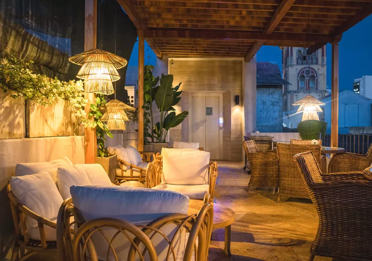 Outdoor patio with light fixtures and a town center in the background