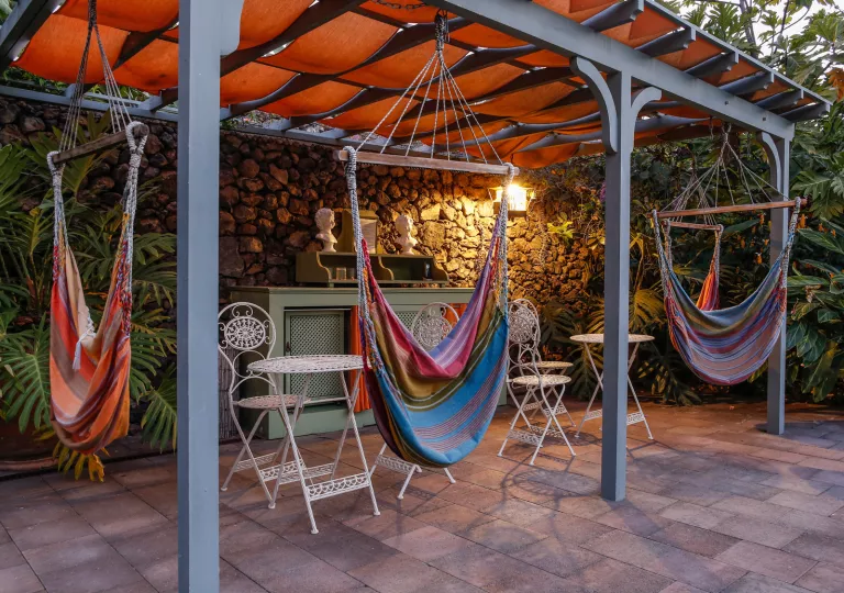 Outdoor patio with 3 hammocks hanging from ropes