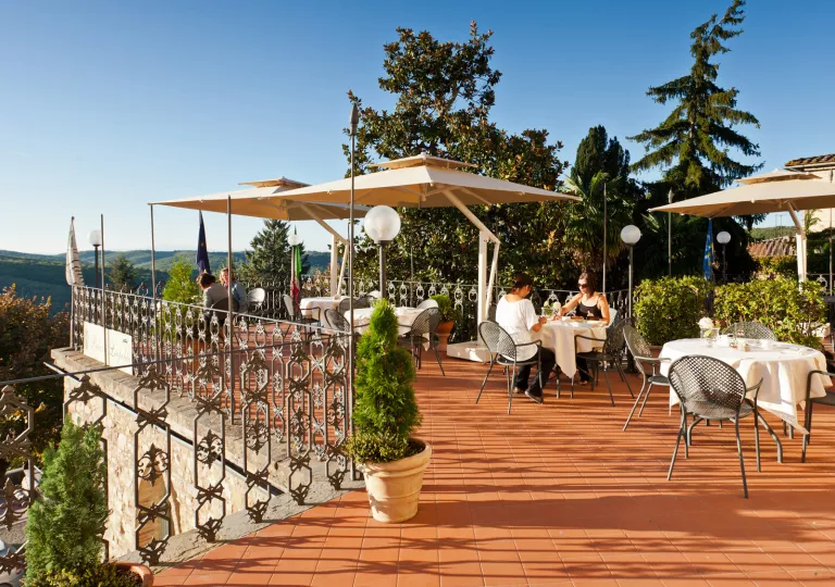 Rooftop patio and dining area, with two women dining at one of the tables