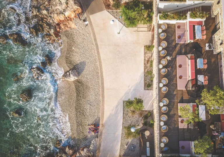 Top view of an outdoor patio, with the beach in front