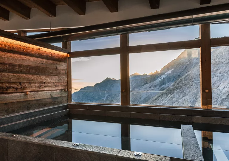 Hot tub spa with a large window looking out to large mountains