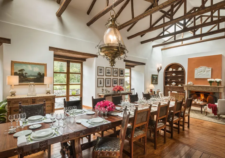 Dining area with a long wooden table and wooden chairs surrounding the table