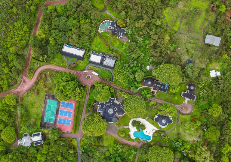 Sky view of hotel complex in the middle of a grassy valley