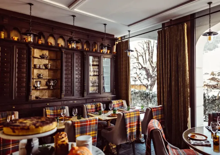Rustic dining room with wooden furniture and plaid blankets on each chair