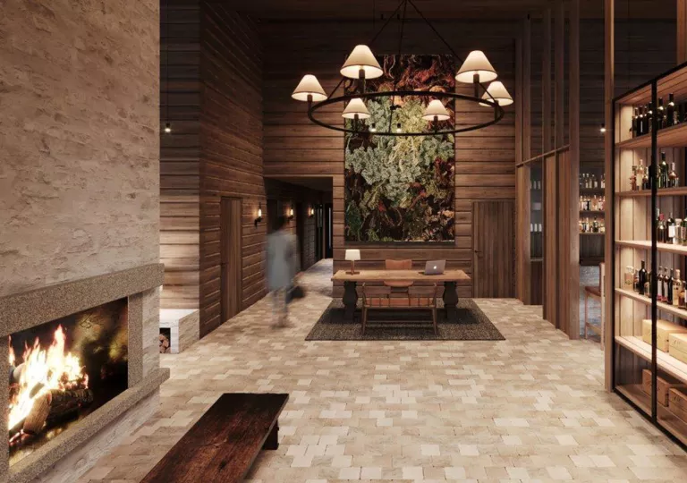 Hotel lounge with a wine rack to the right, and a fireplace and bench to the left