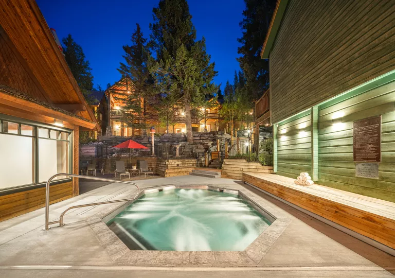 Outdoor hot tub, surrounded by large wooden cabins