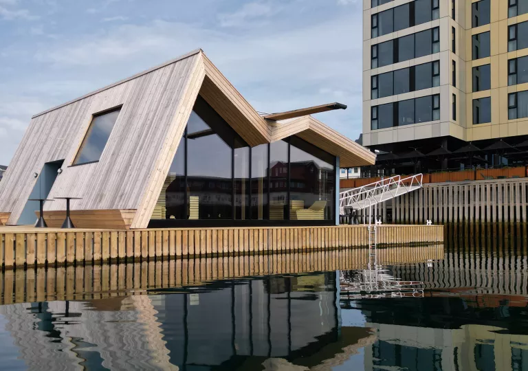 Building with artistic look in front of a lake