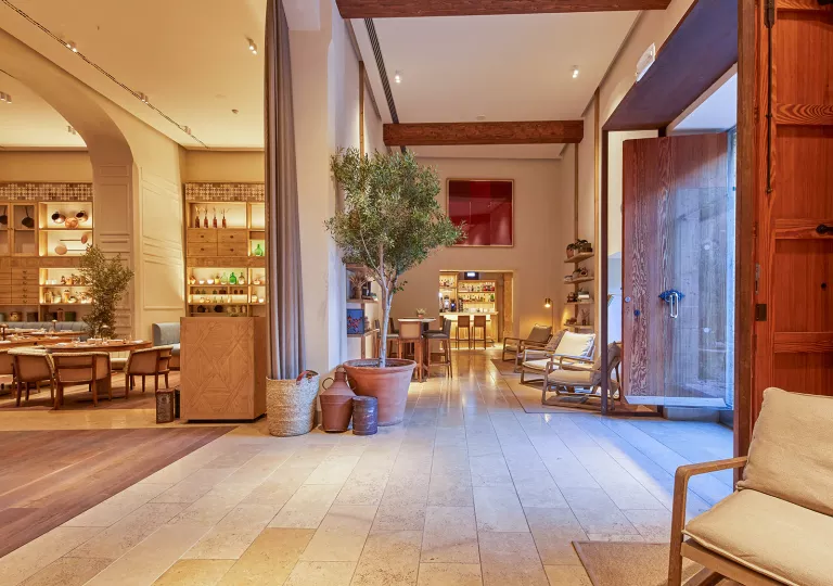 Restaurant dining hall with tables on the left and a waiting area on the right