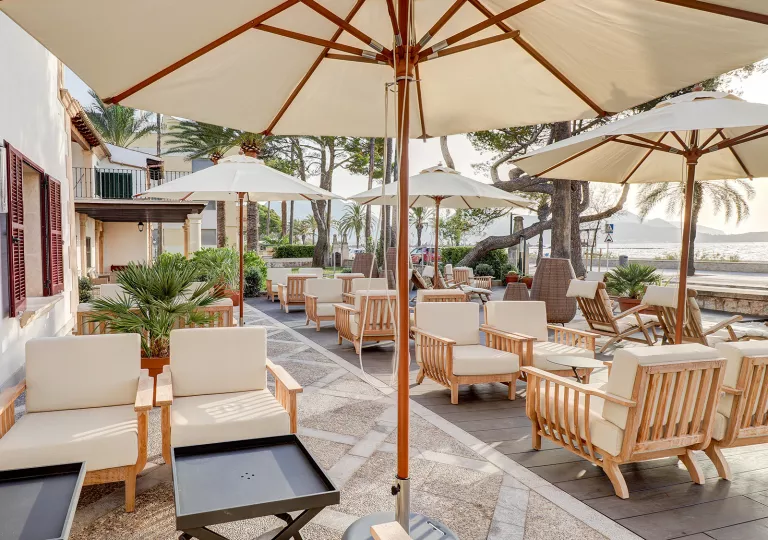 Outdoor patio with white umbrellas and cushioned chairs