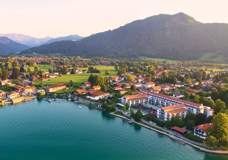 Sky view of a small town with white and brown buildings, with a lake in the center