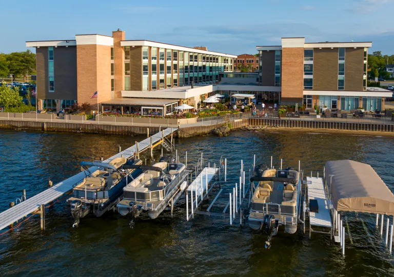 Large hotel complex in front of a dock full of boats