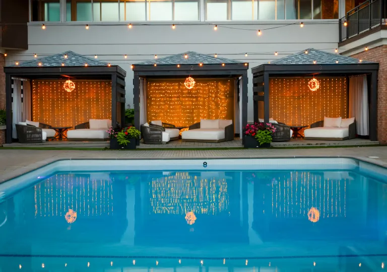 Outdoor pool with cushioned beds surrounding