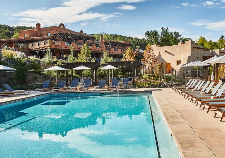 Outdoor pool surrounded by gray, reclining chairs