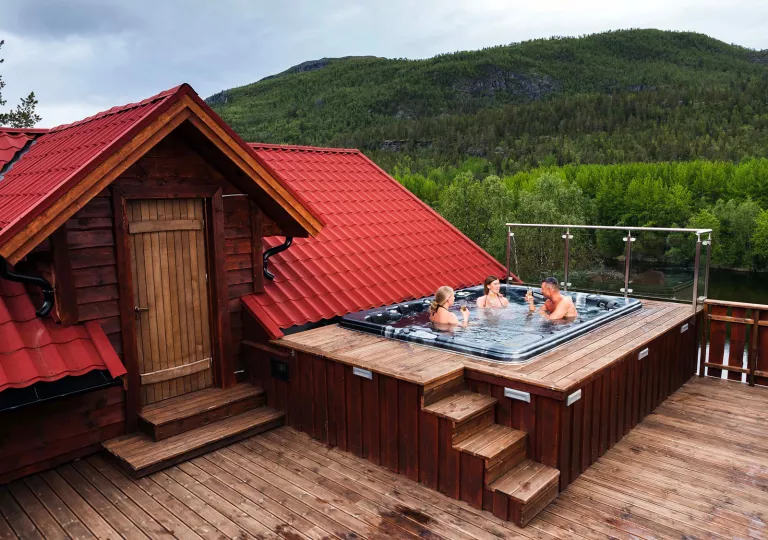 Rooftop with a hot tub and three people sitting inside