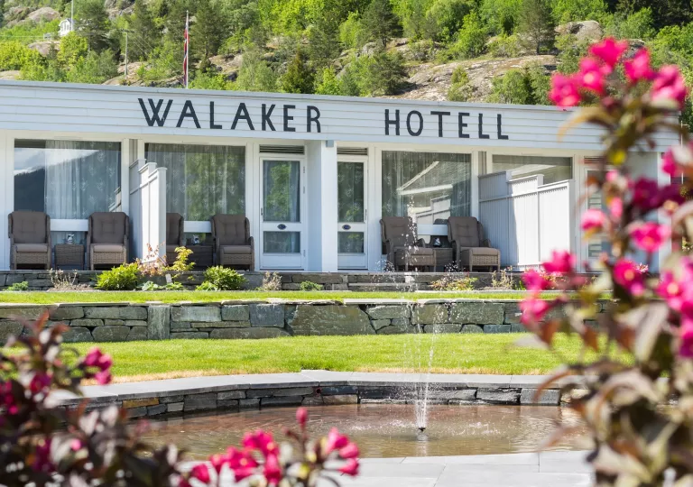Exterior view of white building with a Walker Hotel sign