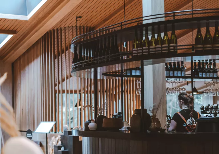 Bar with a bartender behind the counter cleaning glasses