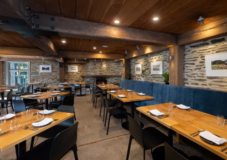 Restaurant with blue benches and wooden dining tables