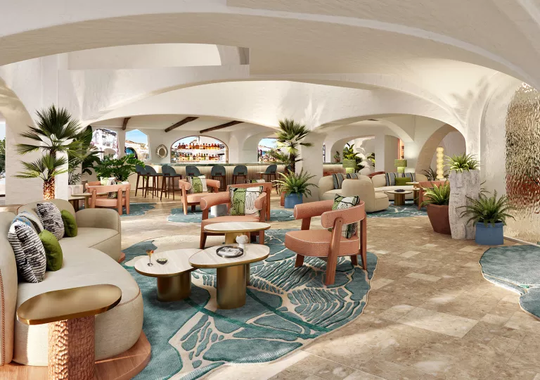 Bar and lounge with a bar counter in the back and cushioned chairs throughout the large room