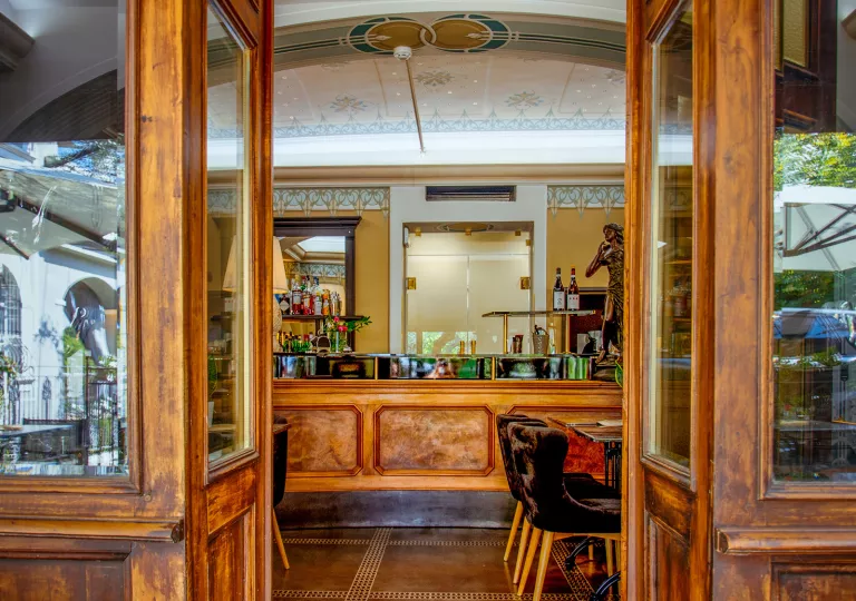 Doorway leading to a bar and lounge with alcohol along the walls