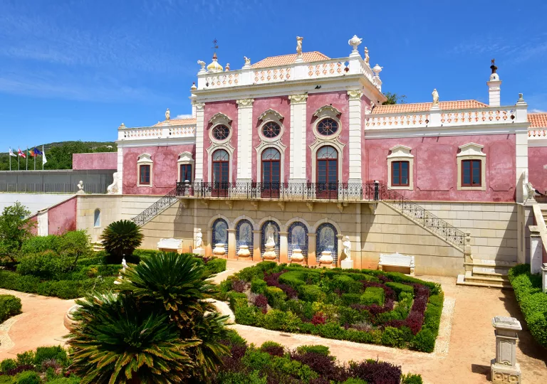 Red brick hotel building with a garden in front
