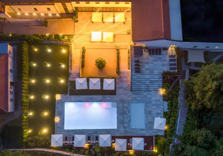 Top-down view of an outdoor pool and hotel complex