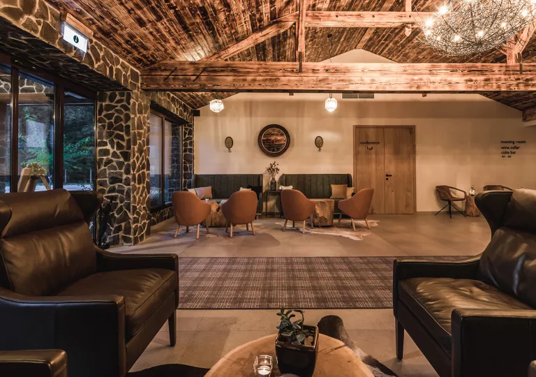 Cabin lobby with stone pillars and leather chairs