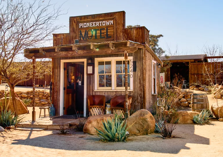 Exterior view of wooden motel entrance with a sign &quot;Pioneertown Motel&quot;
