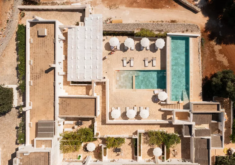 Top view of an outdoor pool and stone building complex