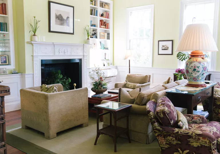 Living room with beige, cushioned sofas in front of a fireplace
