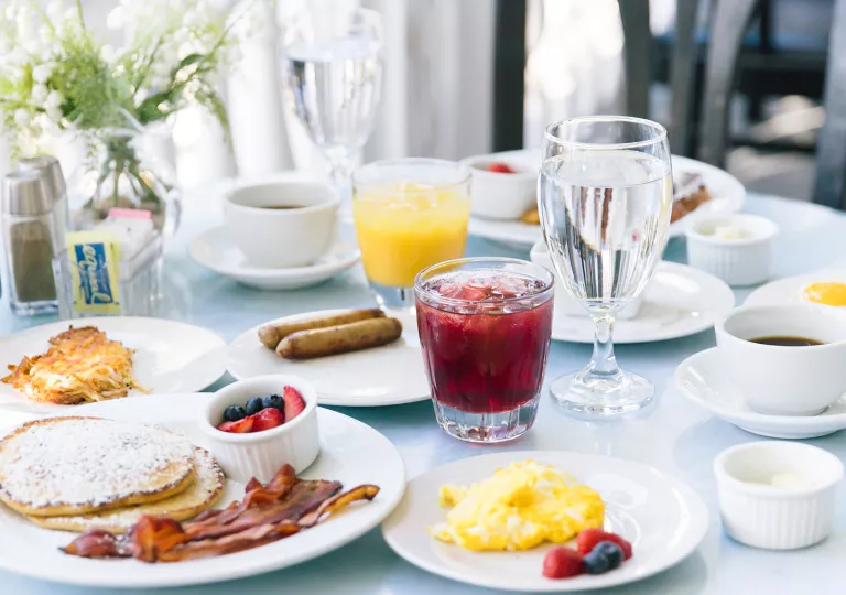 Plate of breakfast foods on top of a white table