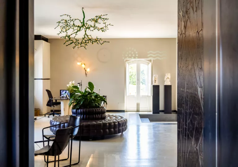 Hotel lobby with marble flooring and a leather couch in the center
