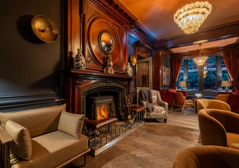 Lobby with art pieces on the wall and cushioned chairs around the room