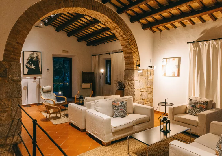 Seating and lounge area with beige couches and stone walls