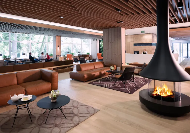 Indoor lounge with a fireplace and leather couches