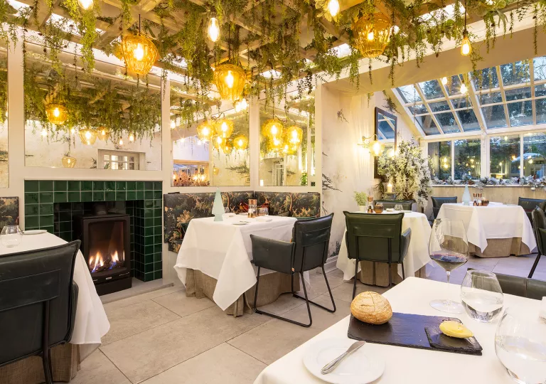 Dining hall with square tables and green leather chairs