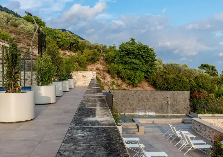 Outdoor rooftop balcony, with a pool on a lower level balcony