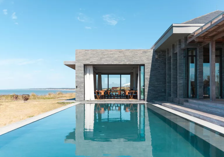 Outdoor pool with a gray stone building in the background
