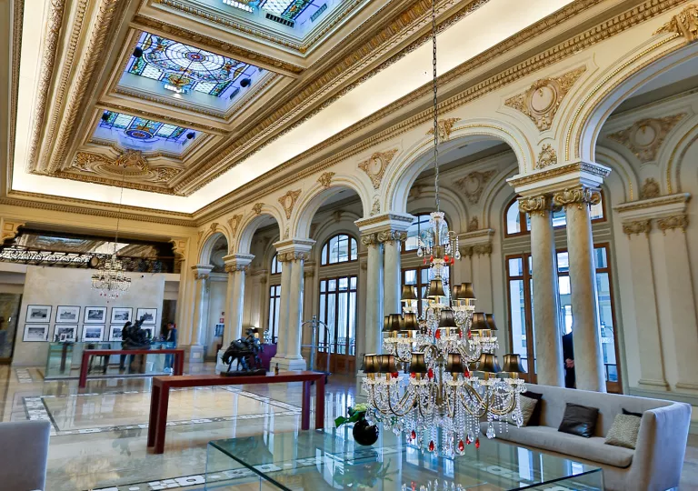 Hotel lobby with couches and a low-hanging chandelier