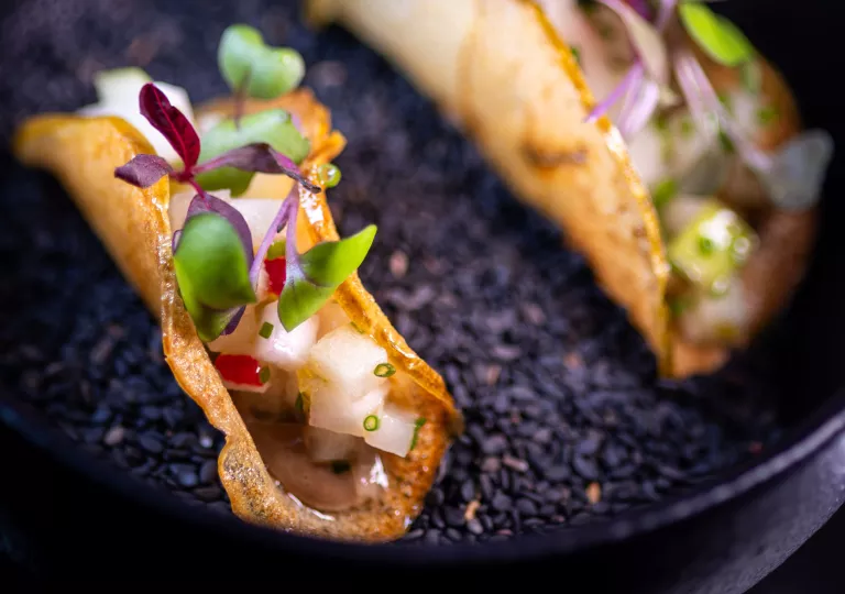 Curled fruit slice with onion and microgreens