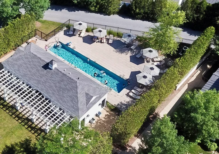 Sky view of gray building with an outdoor pool to the right