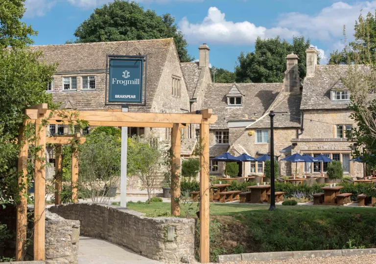 Exterior view of stone and brick building with an outdoor patio