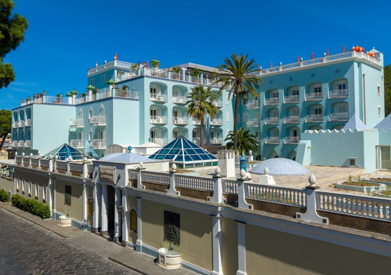 The light blue exterior, tiered architecture and glass pyramid skylights of the Palazzo Manzi Terme &amp; Spa located in Casamicciola Terme on the island of Ischia, Italy.