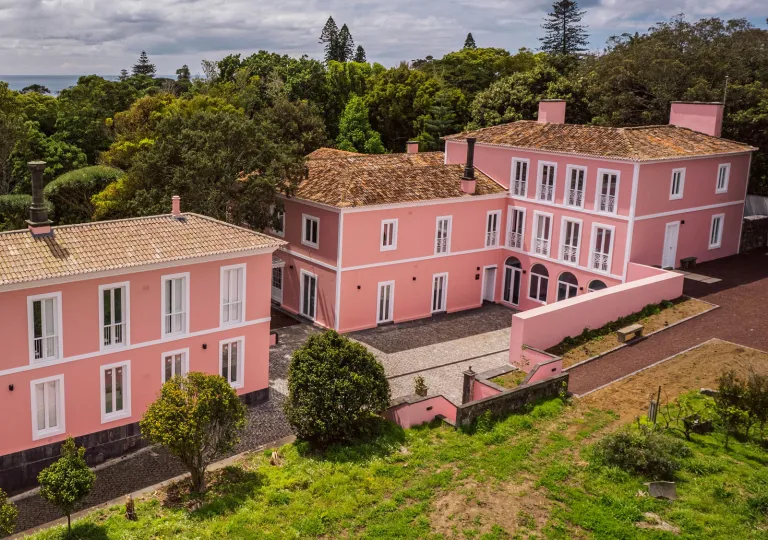 Exterior view of pink hotel complex building