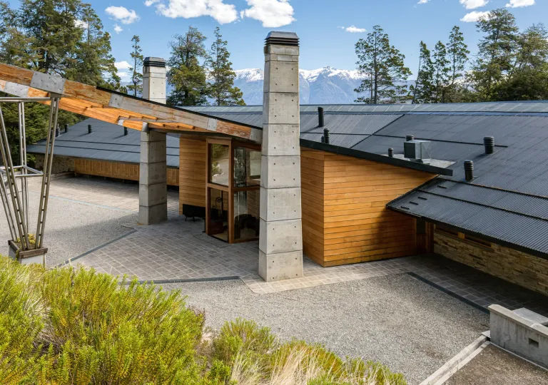 The entrance of Calfuco Wine Hotel &amp; Spa features a striking modern design blending rustic materials, located in Villa La Angostura, Neuquén Province, Argentina.