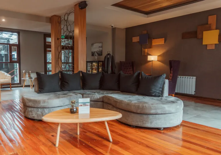 Lounge and seating area with a large sofa on a wooden floor